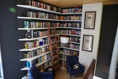 Floating library shelving and walnut ladder.