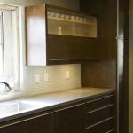 The upper cabinets feature lift doors as well as sliding glass doors that flip up out of the way.