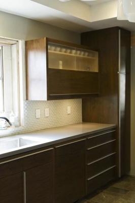 The upper cabinets feature lift doors as well as sliding glass doors that flip up out of the way.