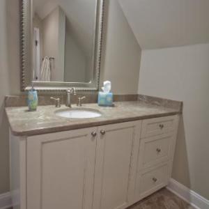 These painted and glazed vanities were designed to match the existing cabinetry in the master bath.