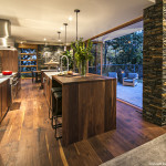 Kitchen, shot from the seating area; in this open plan design, the kitchen and living areas flow together.