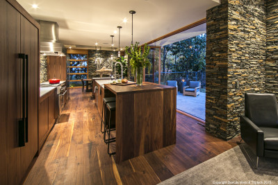 Kitchen, shot from the seating area; in this open plan design, the kitchen and living areas flow together.