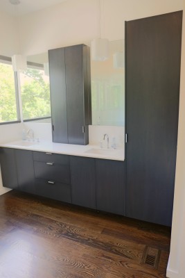 Master bathroom: Floating cabinets made with grain-matched walnut veneer.