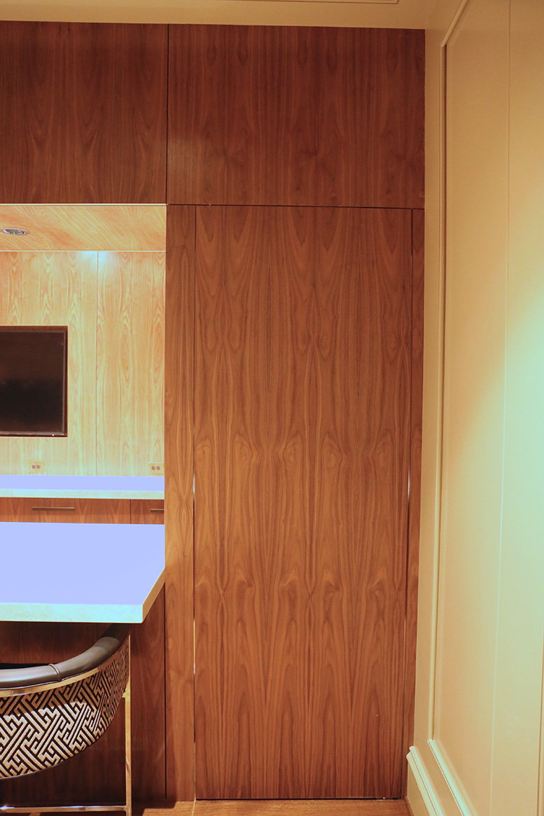 Grain matched panels on the upper soffit. We created a door on a pivot hinge to lead to the back of the bar.