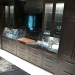 Close-up of cabinetry in bar area; a warming drawer, oven and microwave are hidden away in these cabinets.
