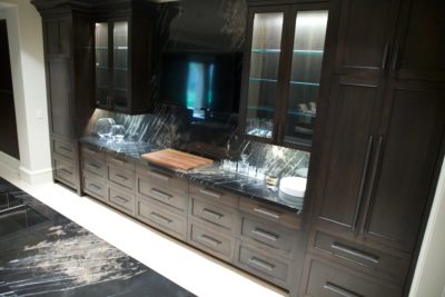 Close-up of cabinetry in bar area; a warming drawer, oven and microwave are hidden away in these cabinets.